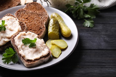 Photo of Delicious sandwiches with lard spread on black wooden table, closeup