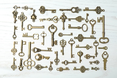 Photo of Flat lay composition with old vintage keys on wooden background