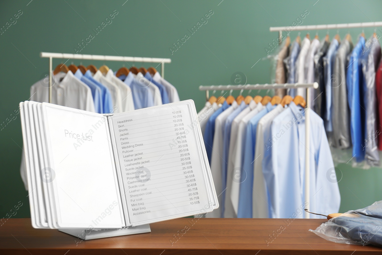 Photo of Workplace of receptionist with price list at dry-cleaner's