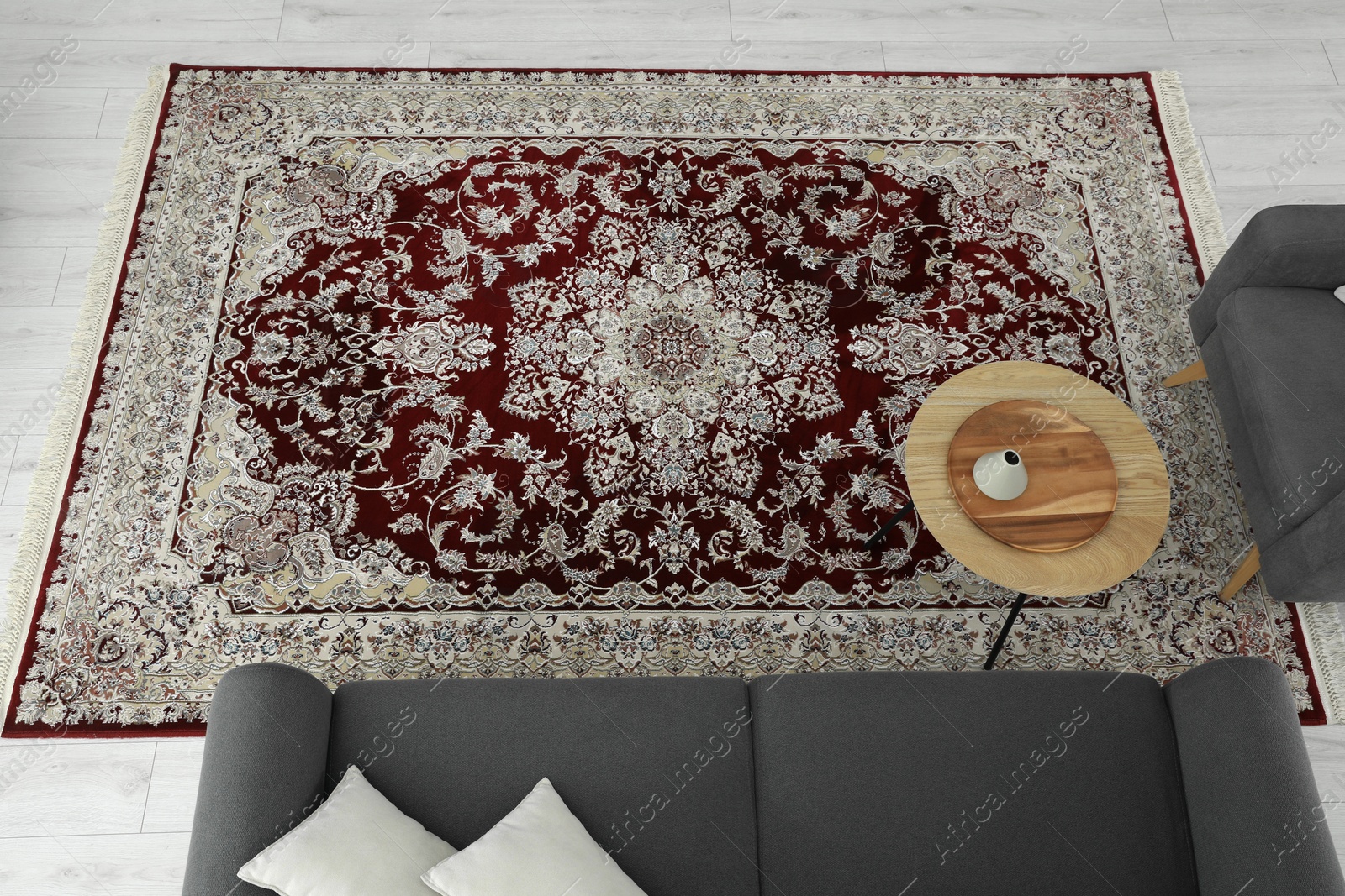 Photo of Cozy room interior with stylish furniture and soft carpet with beautiful pattern, view from above