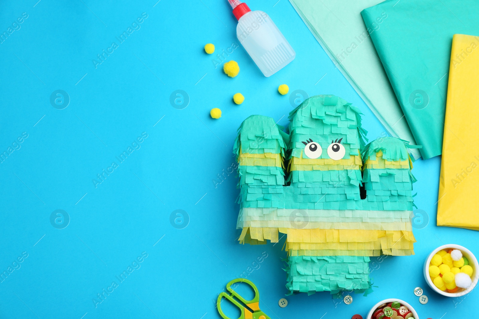 Photo of Flat lay composition with cardboard cactus on light blue background, space for text. Pinata diy