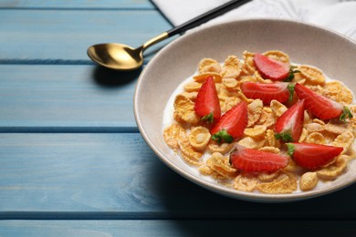Photo of Delicious crispy cornflakes with milk and fresh strawberries on light blue wooden table, closeup. Space for text