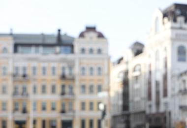 Photo of Blurred view of city street with modern buildings