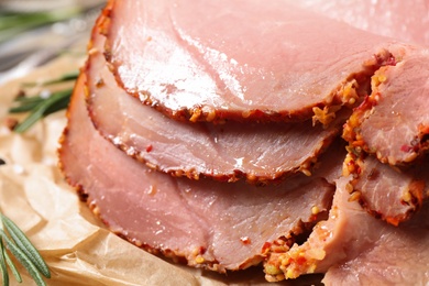 Slices of delicious cooked ham on parchment, closeup