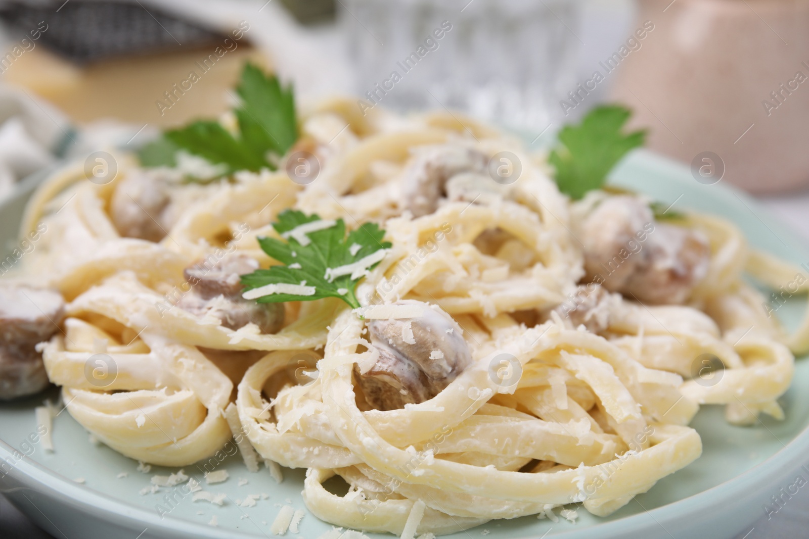 Photo of Delicious pasta with mushrooms and cheese on plate, closeup