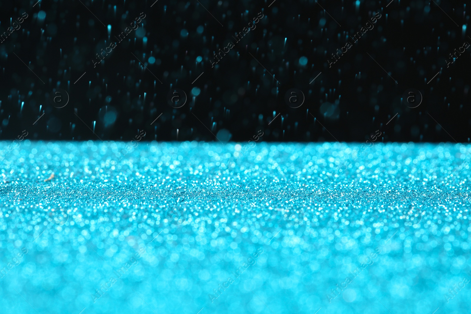 Photo of Glitter on table against dark background, space for text. Bokeh effect