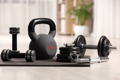 Photo of Many different sports equipment on floor indoors