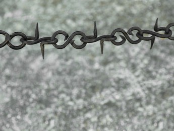 Beautiful black chain with spikes on grey background