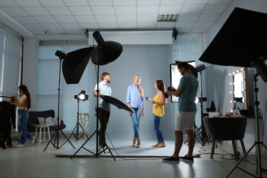 Professional team working with model in photo studio