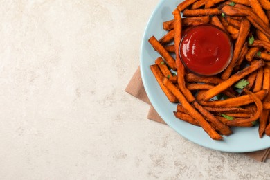 Delicious sweet potato fries served with sauce on light table, top view. Space for text