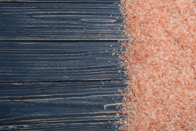 Pink himalayan salt on blue wooden table, flat lay. Space for text