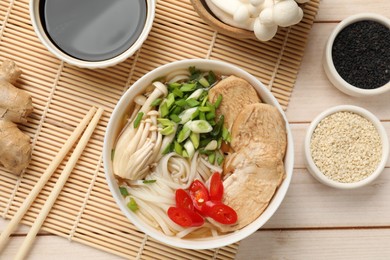 Photo of Delicious ramen with meat and ingredients on white wooden table, flat lay. Noodle soup