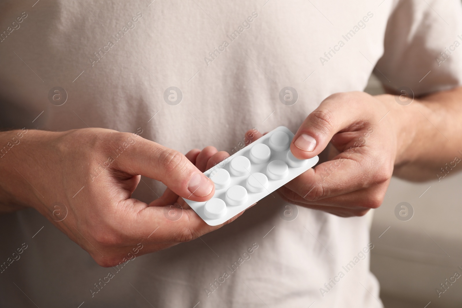 Photo of Man taking pill out from blister pack, closeup