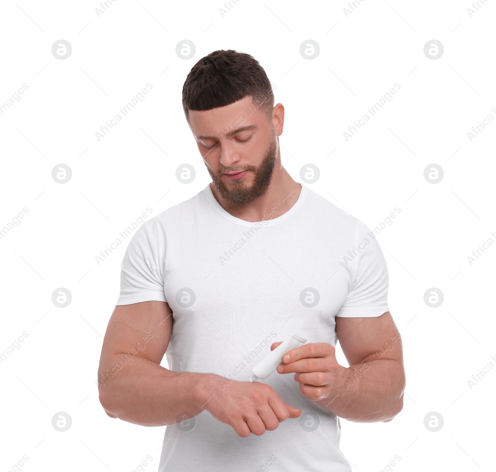 Photo of Handsome man applying body cream onto his hand on white background