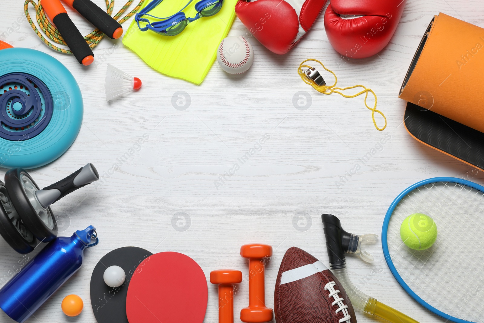 Photo of Frame of sports equipment on white wooden background, flat lay. Space for text