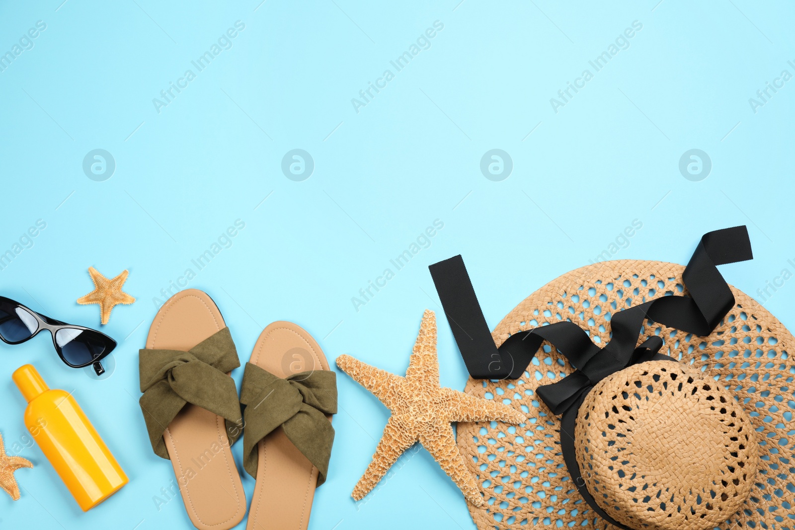 Photo of Flat lay composition with beach objects on light blue background, space for text