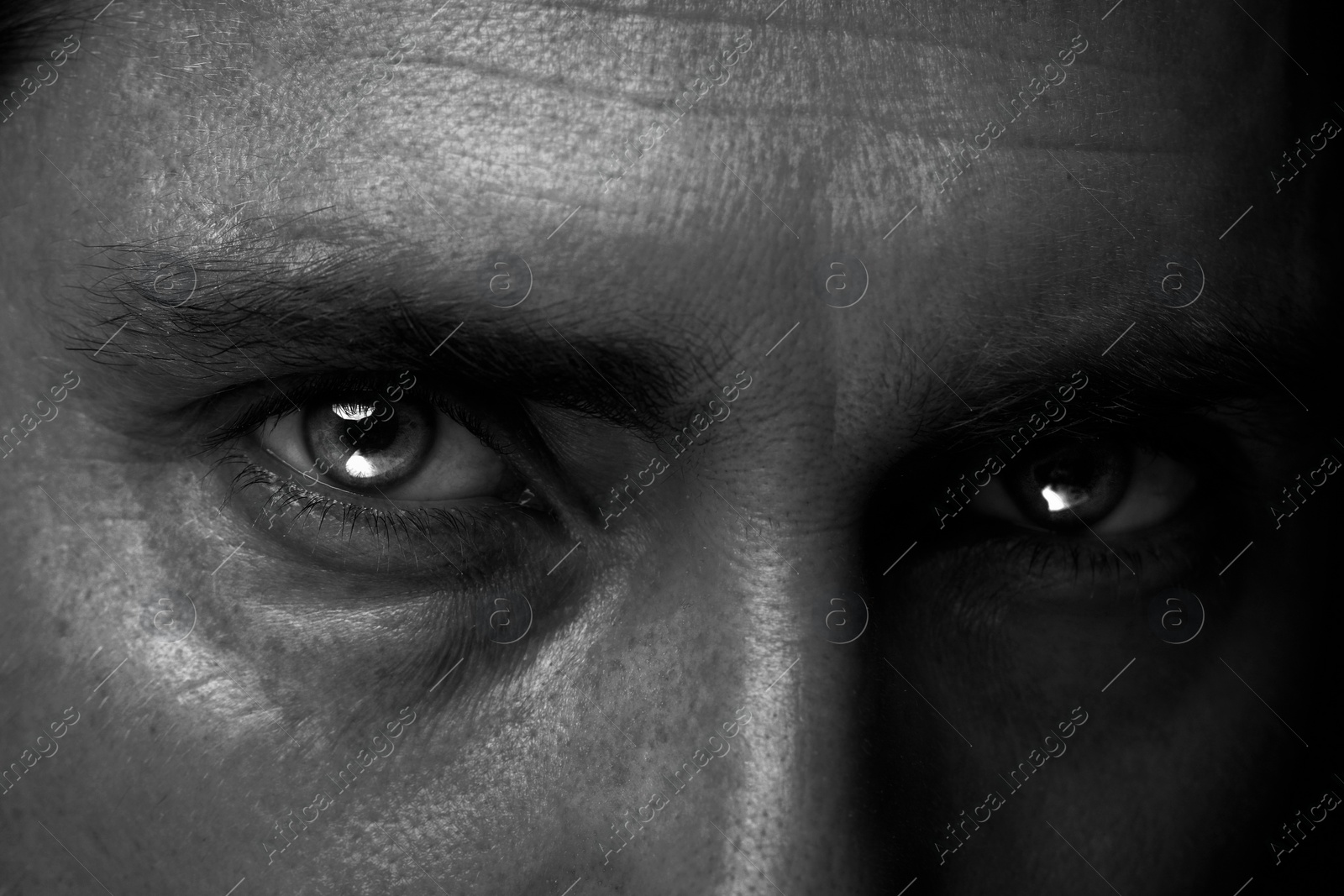 Image of Man with captivating eyes, closeup. Black and white effect