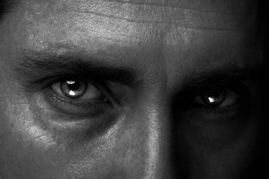 Image of Man with captivating eyes, closeup. Black and white effect