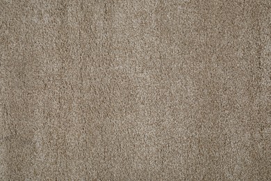 Photo of Stylish soft beige carpet as background, top view
