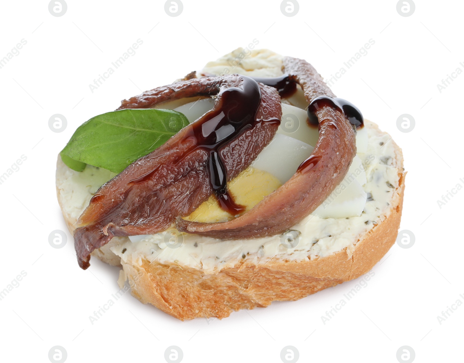 Photo of Delicious bruschetta with anchovies, eggs, basil and sauce on white background