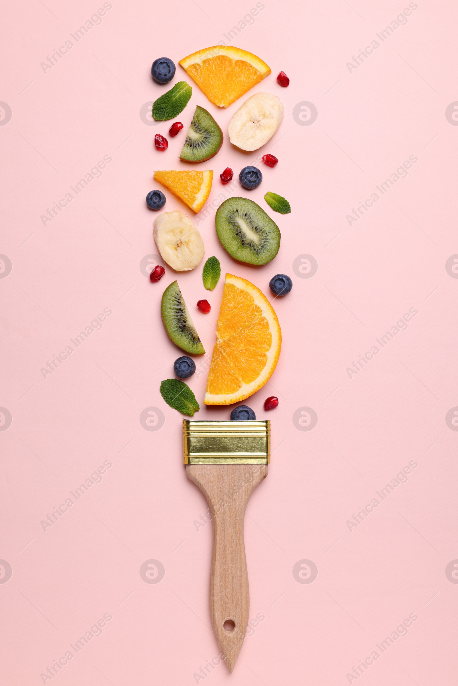 Photo of Creative flat lay composition with paint brush, fruits and berries on beige background