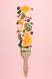 Photo of Creative flat lay composition with paint brush, fruits and berries on beige background