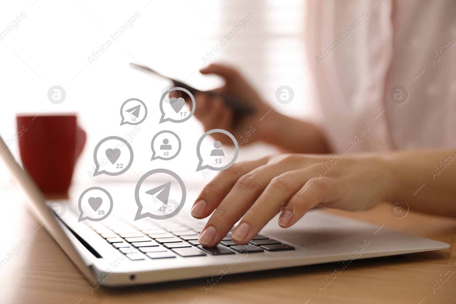 Image of Different virtual icons and young woman using laptop and smartphone at table indoors, closeup. SMM (Social media marketing) concept