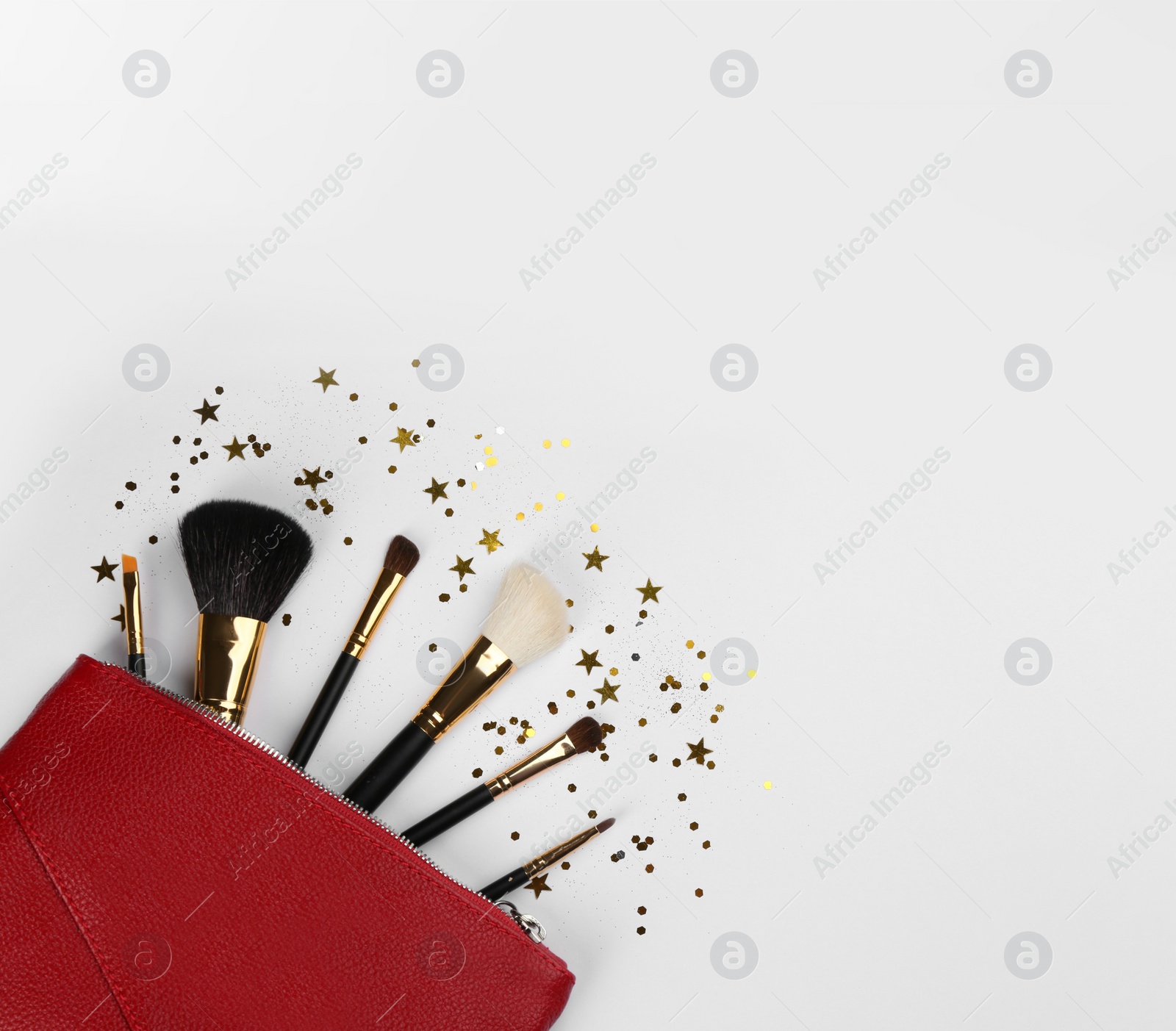 Photo of Different makeup brushes, case and shiny confetti on white background, flat lay. Space for text