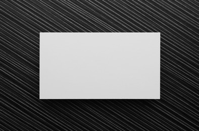 Blank business card on black wooden table, top view. Mockup for design