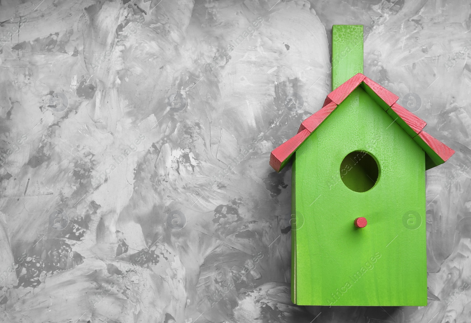Photo of Beautiful green bird house on light grey background, space for text