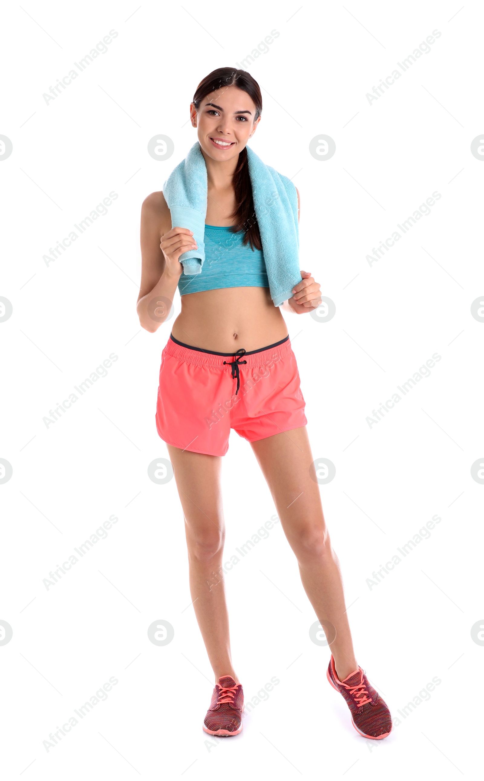 Photo of Beautiful young woman in sportswear with towel on white background