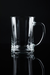 Photo of New empty beer glass on black background