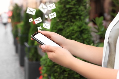 Image of Woman with smartphone chatting outdoors, closeup. Many illustrations of envelope as incoming messages over device