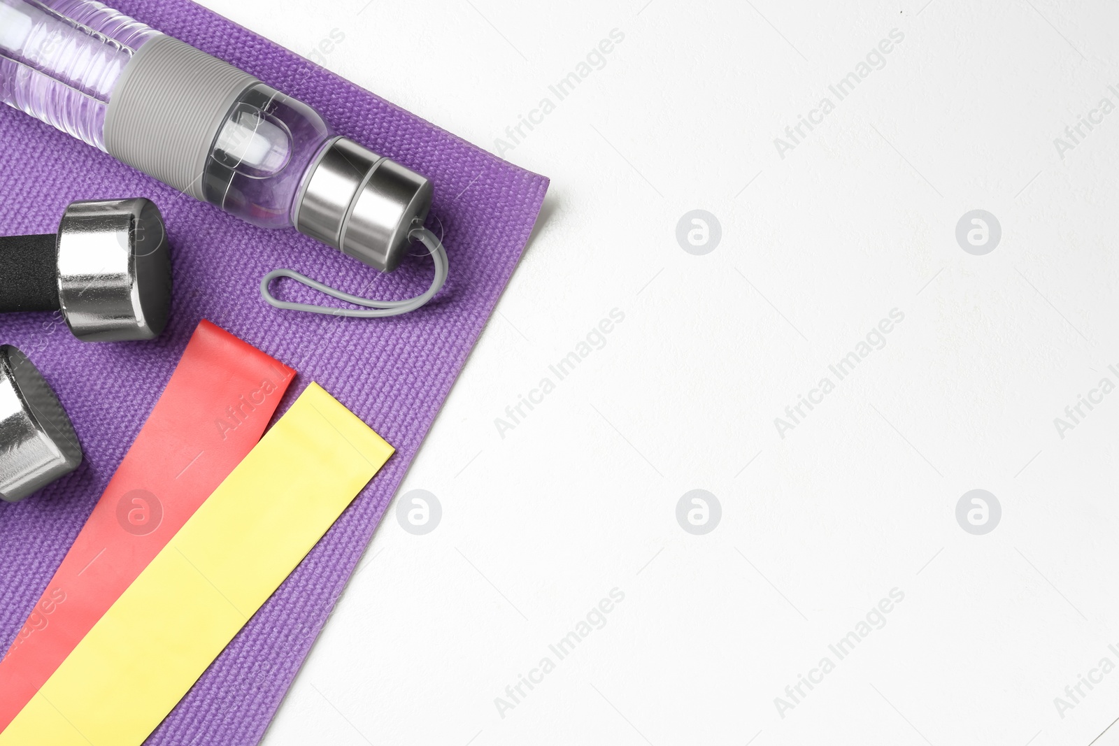 Photo of Flat lay composition with fitness elastic bands on white background