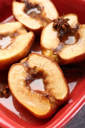 Photo of Tasty baked quinces with honey in dish on table, closeup