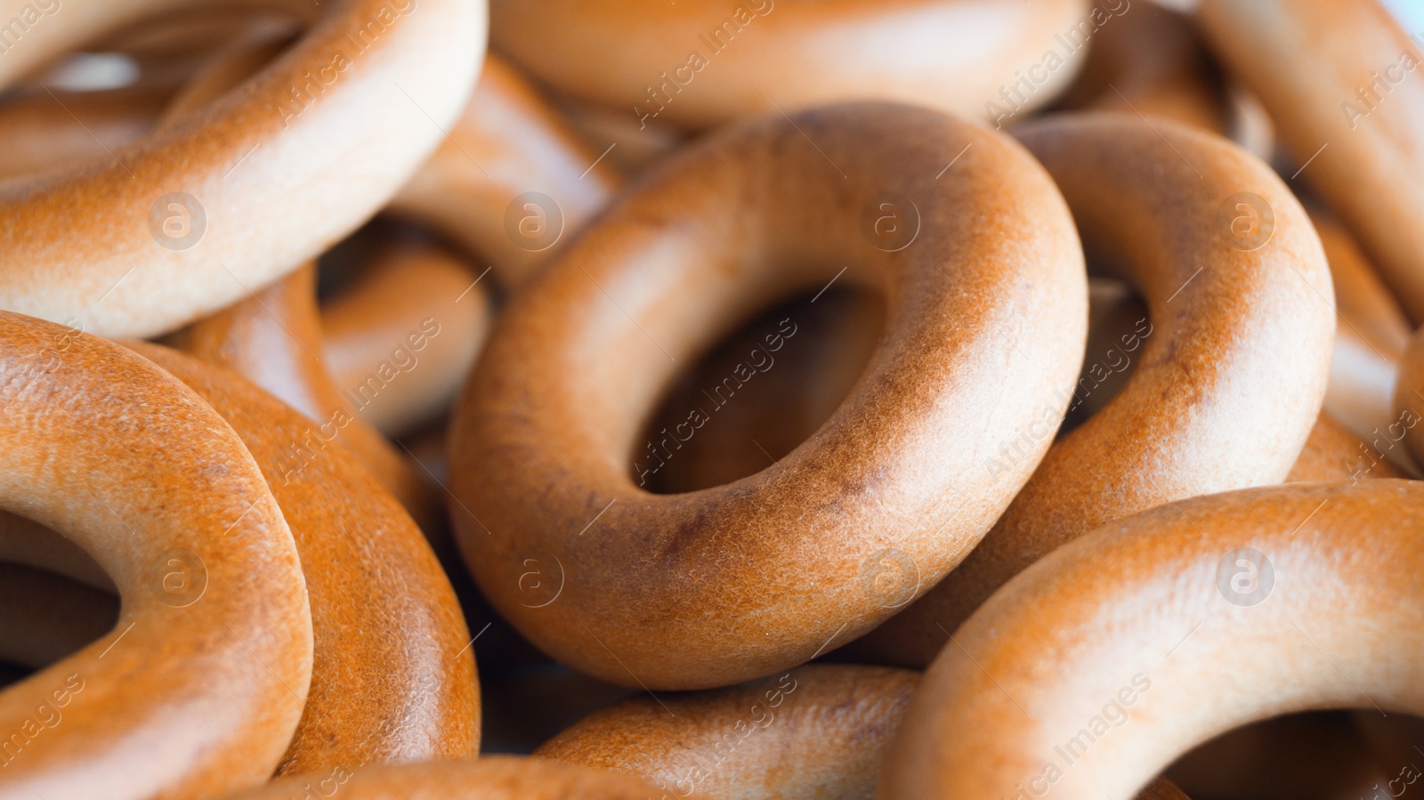 Photo of Tasty dry bagels (sushki) as background, closeup