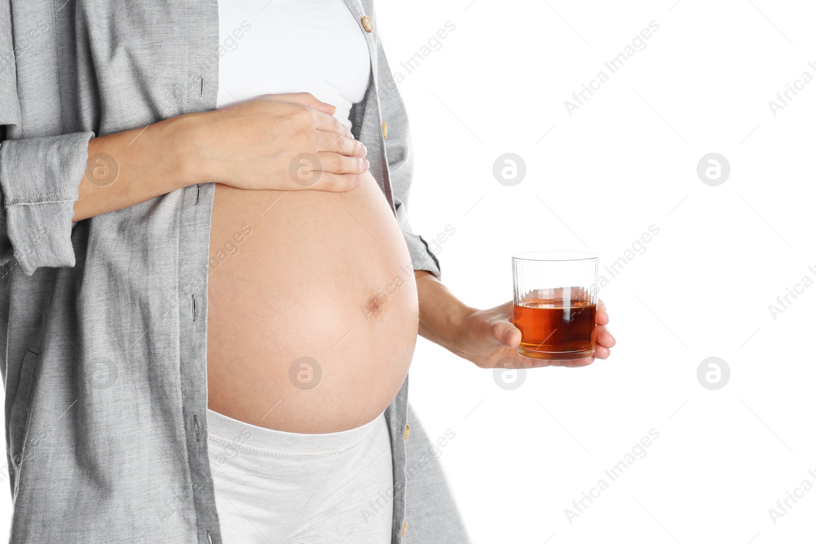 Photo of Pregnant woman with glass of whiskey on white background. Alcohol addiction