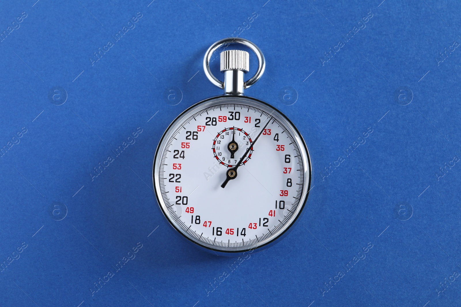 Photo of Vintage timer on blue background, top view. Measuring tool