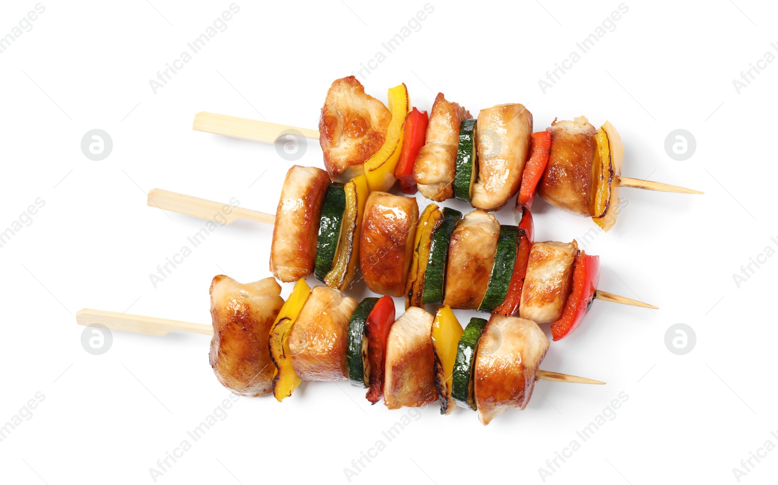 Photo of Delicious chicken shish kebabs with vegetables on white background, top view