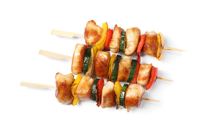 Delicious chicken shish kebabs with vegetables on white background, top view