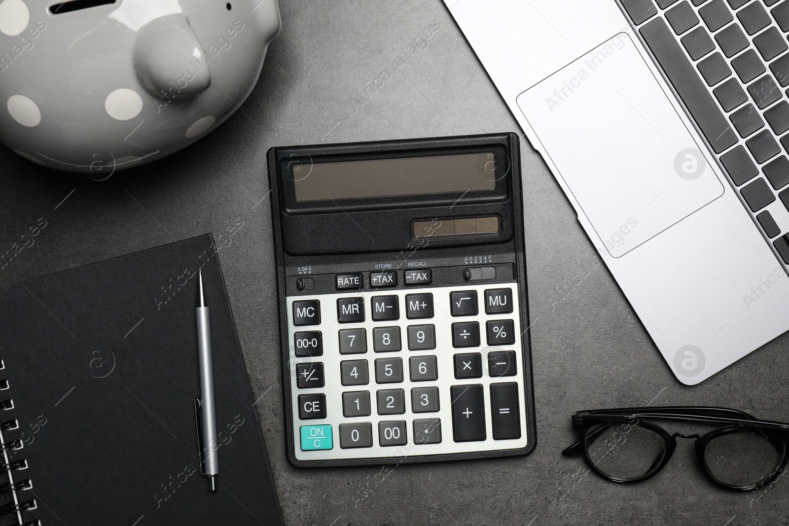 Photo of Flat lay composition with calculator on dark gray table