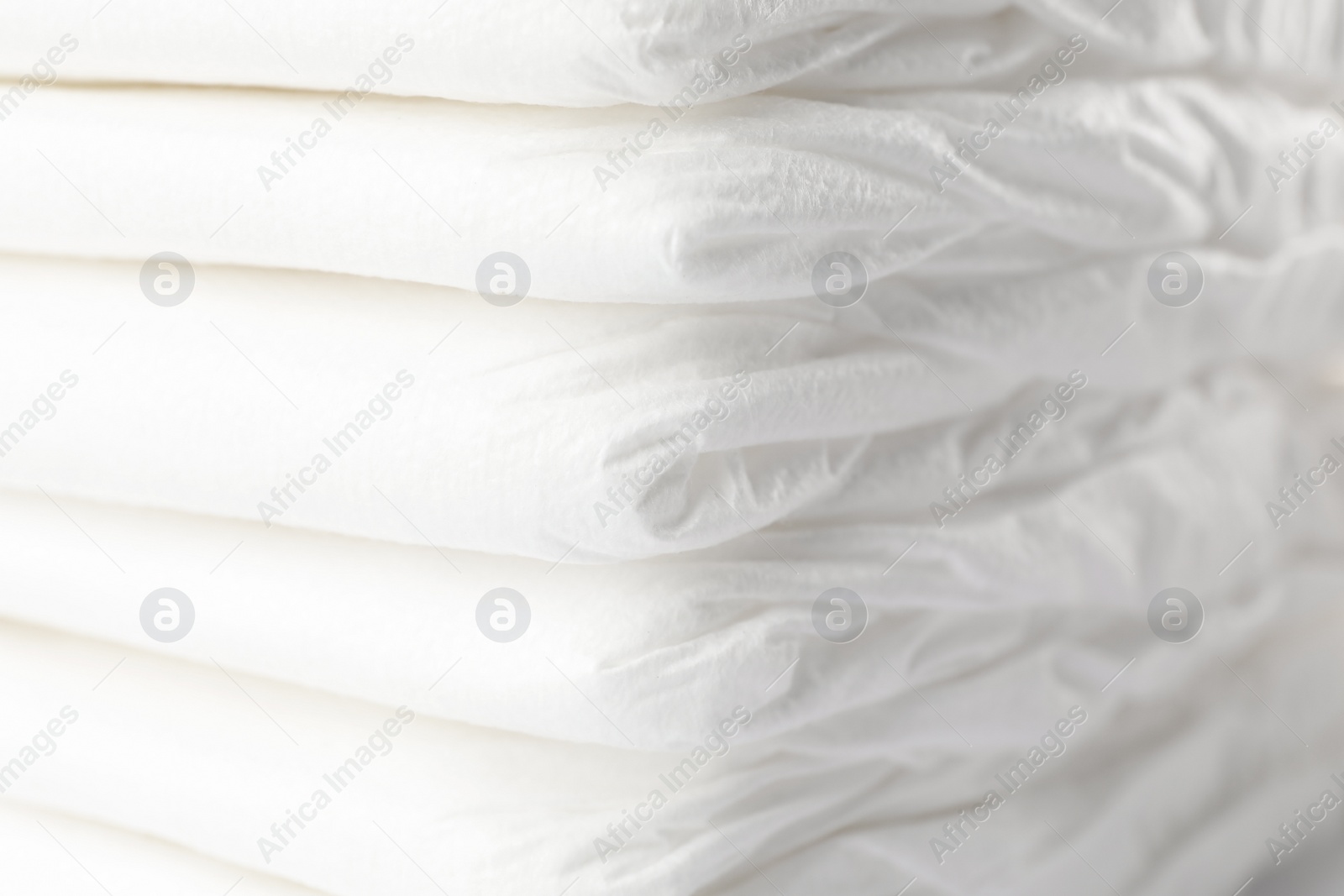 Photo of Stack of baby diapers as background, closeup