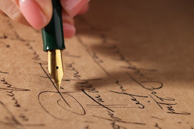 Photo of Woman writing letter with fountain pen, closeup