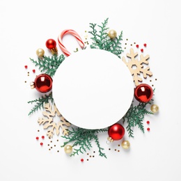 Photo of Flat lay composition with Christmas decor and blank card on white background. Space for text