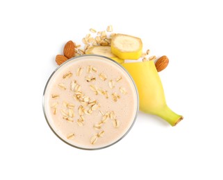Photo of Glass of tasty banana smoothie with almonds and oatmeal on white background, top view