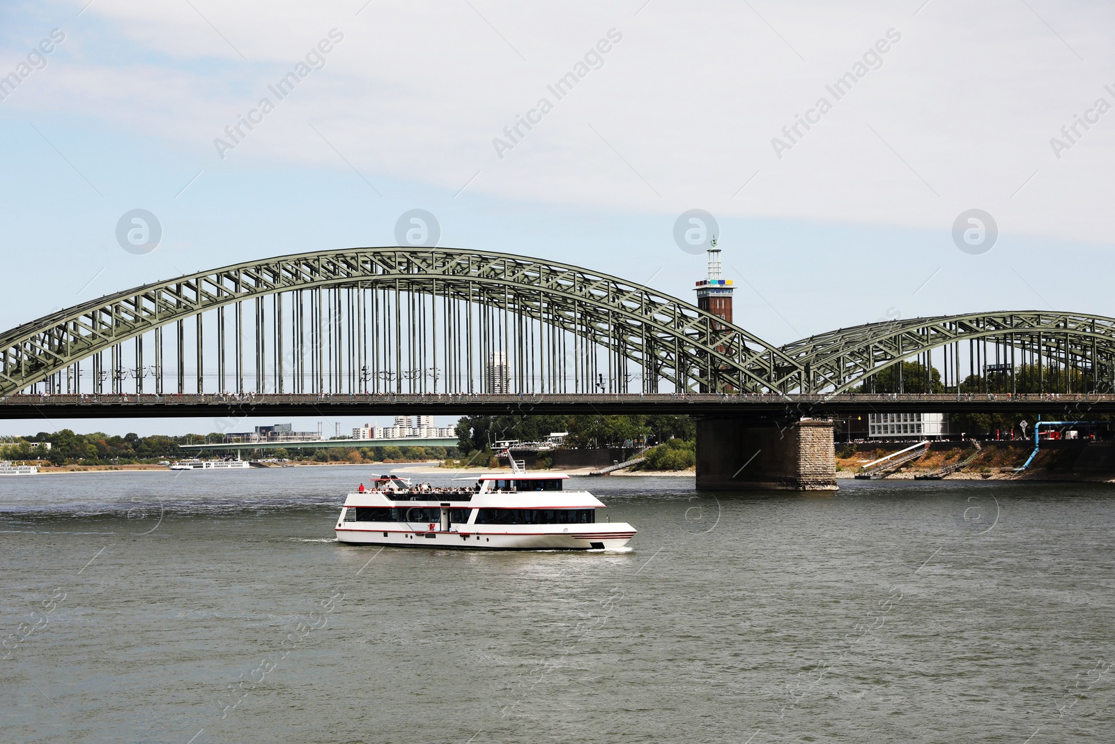 Photo of Picturesque view of a modern bridge over river and ferry boat