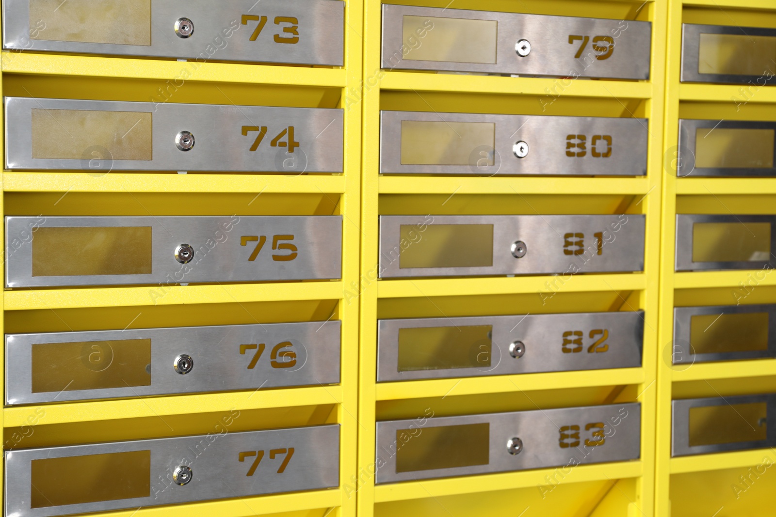 Photo of Many closed metal mailboxes with keyholes and numbers as background