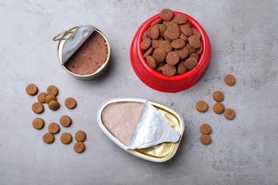 Photo of Wet and dry pet food on grey table, flat lay