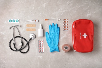 Photo of Flat lay composition with first aid kit on gray background