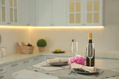 Photo of Beautiful table setting in modern kitchen. Interior design